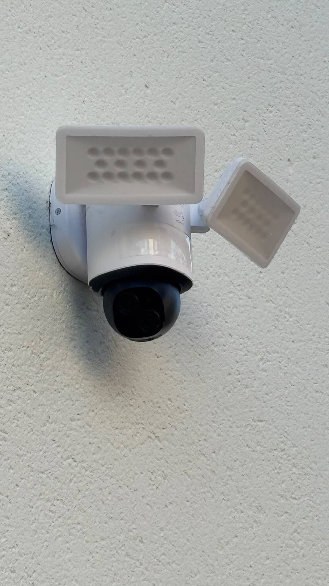 Close-up of the floodlight camera with its two lights angled