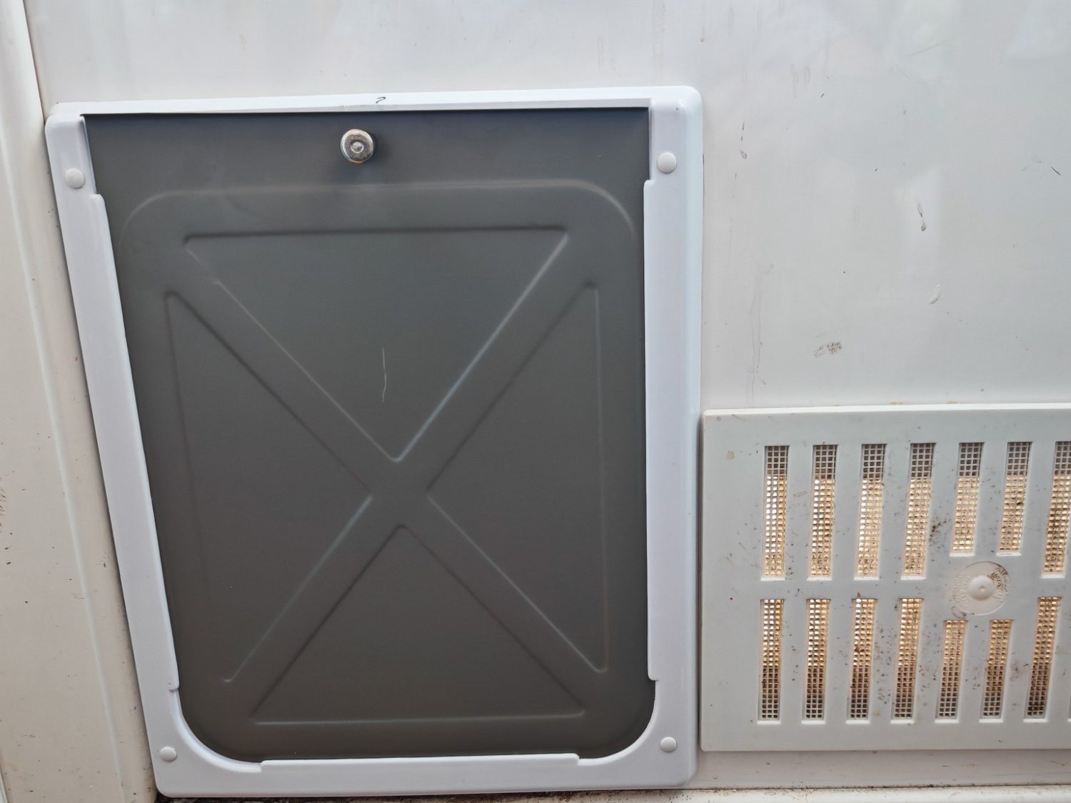 The other side of the same door, with the closing panel slid into the dog flap frame
