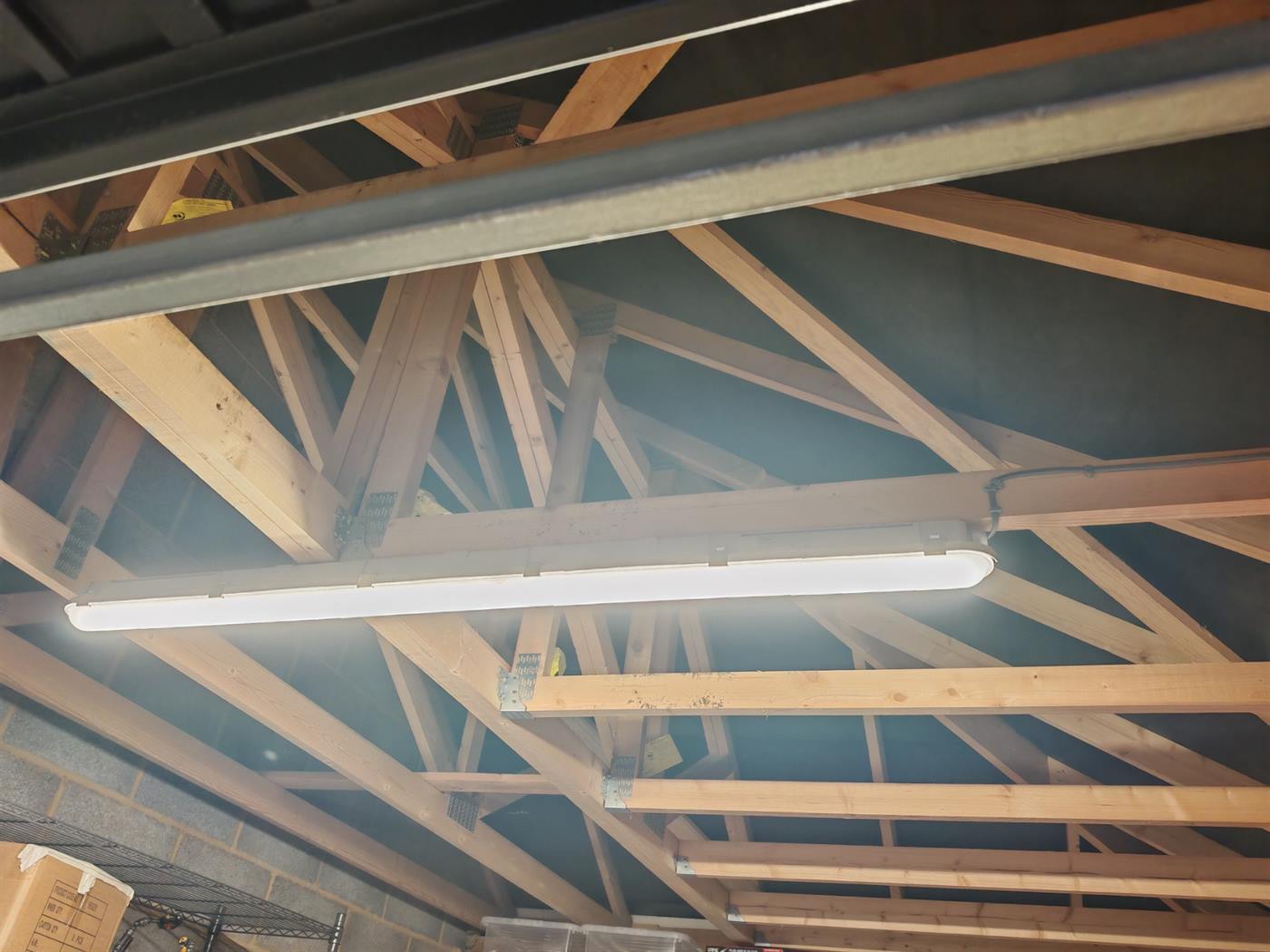 LED strip light fitted along the ridge of a garage roof with exposed timber trusses