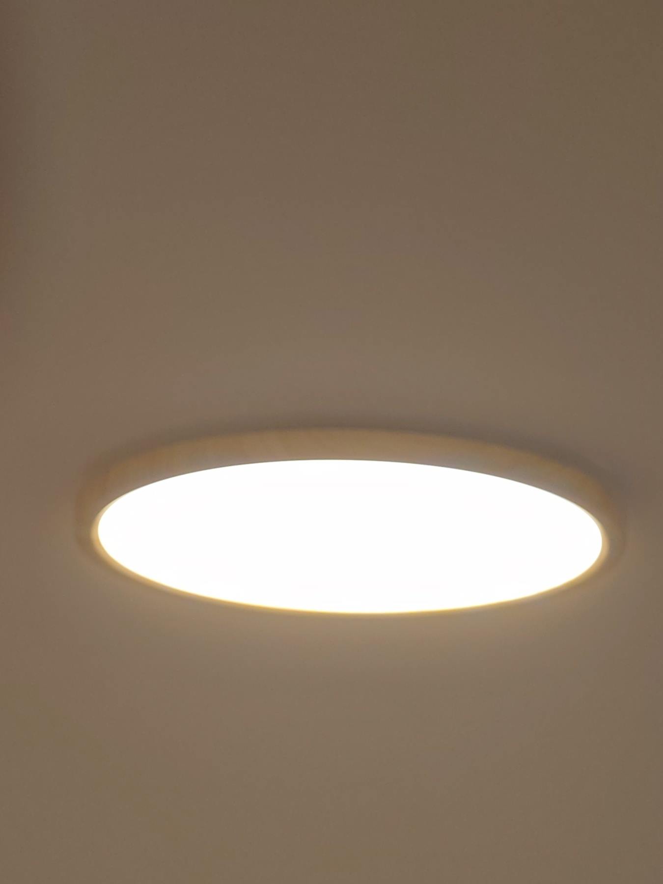 Oak-rimmed flush LED ceiling panel switched on, fitted flat to the ceiling